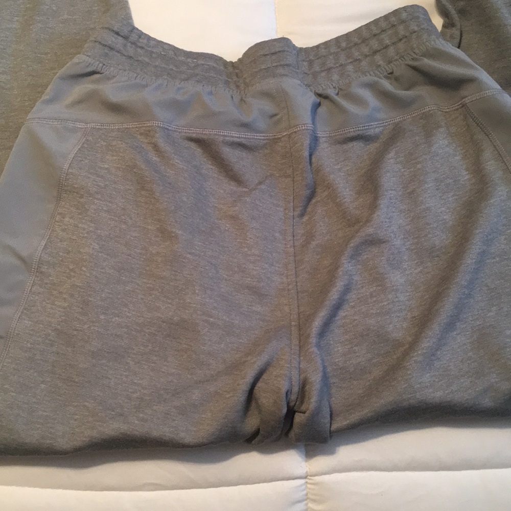 Gray Under Armour sweatpants with blue zipper detail. - Picture 5 of 5